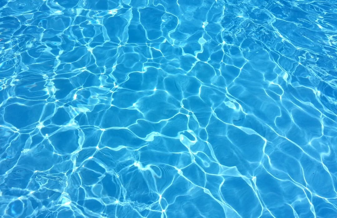 Pool safety camera view of backyard pool with Pool Angel hub delivering real-time submersion and distress alerts